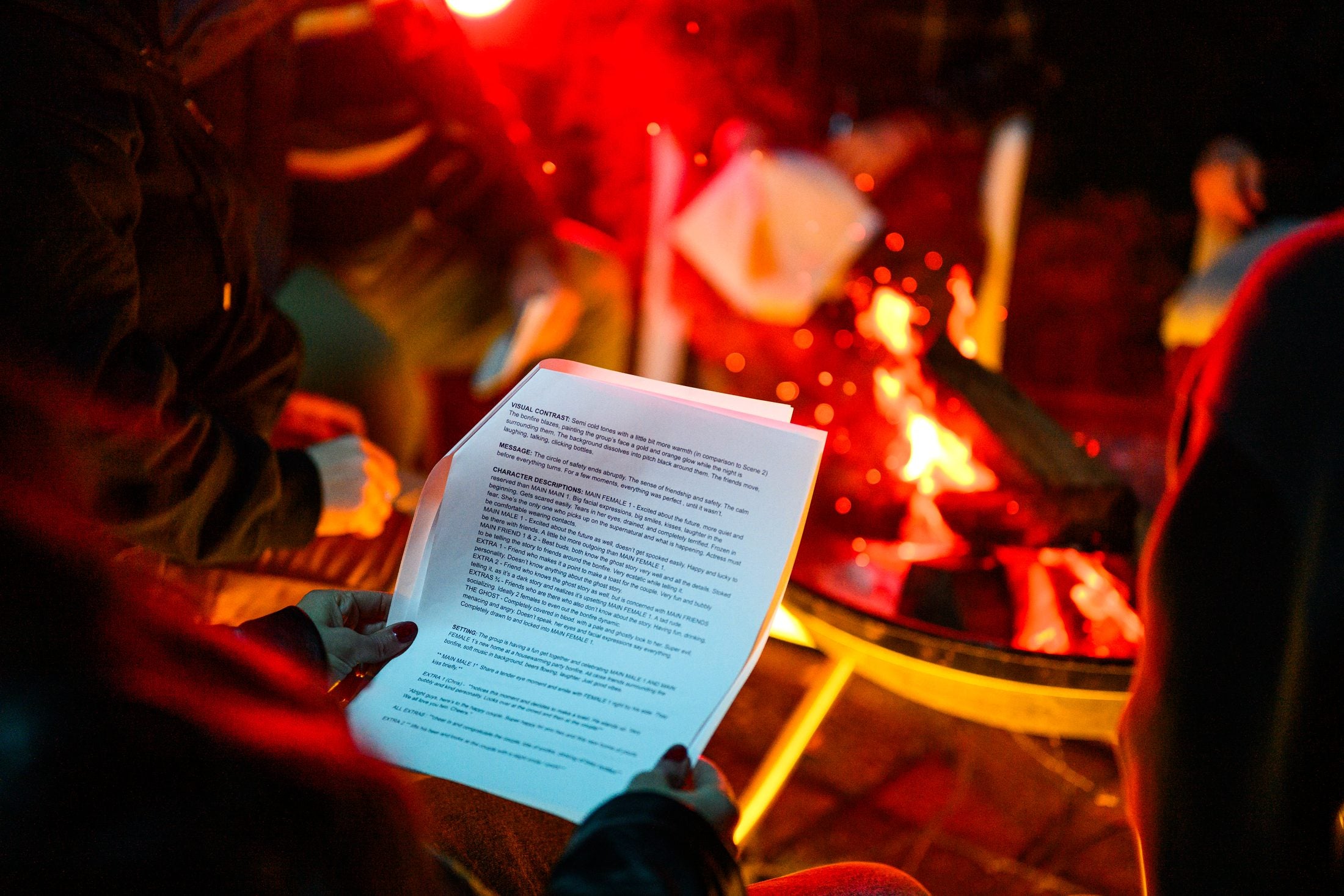 Script pages held up in front of the fire