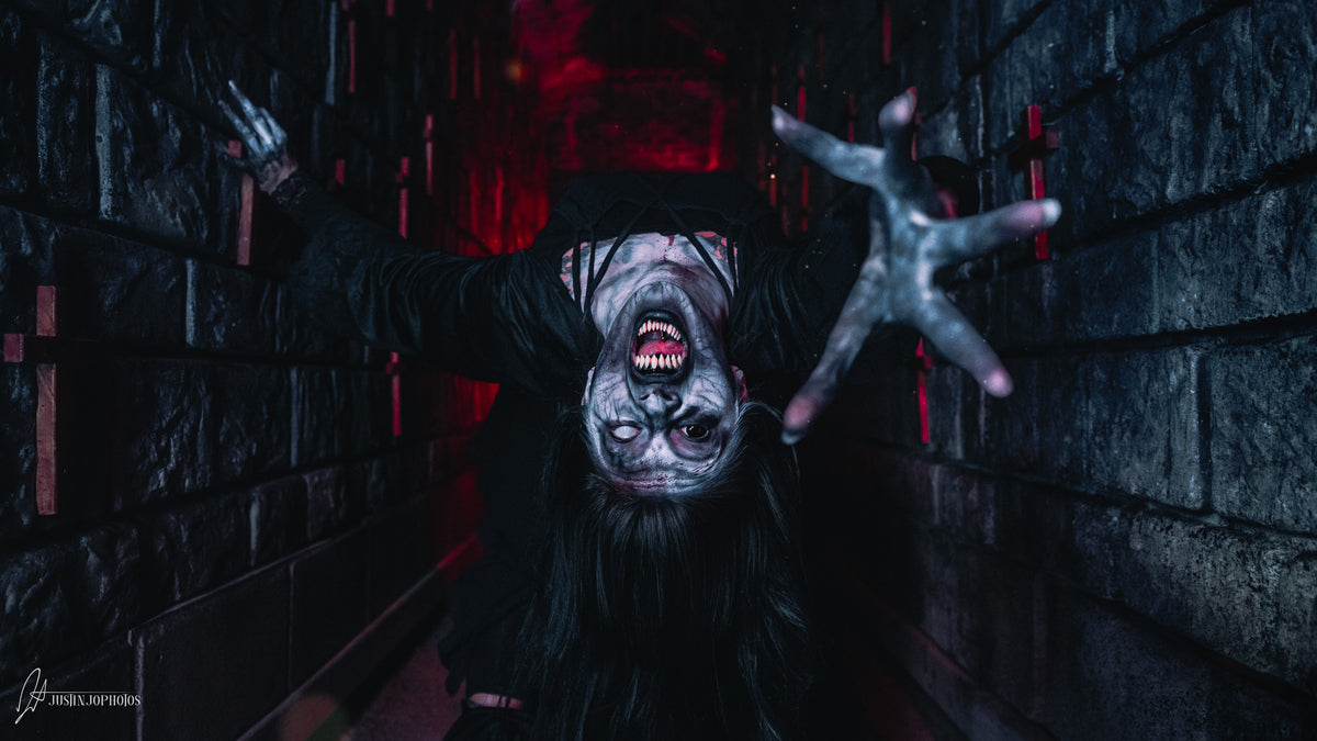 Two figures in red light inside the haunt