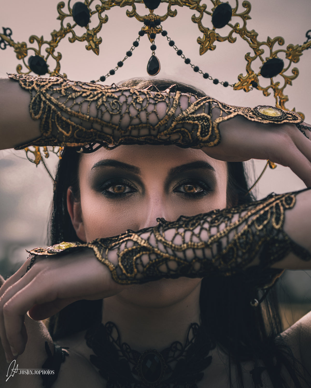 Blonde woman in an ornate gold mask and chains